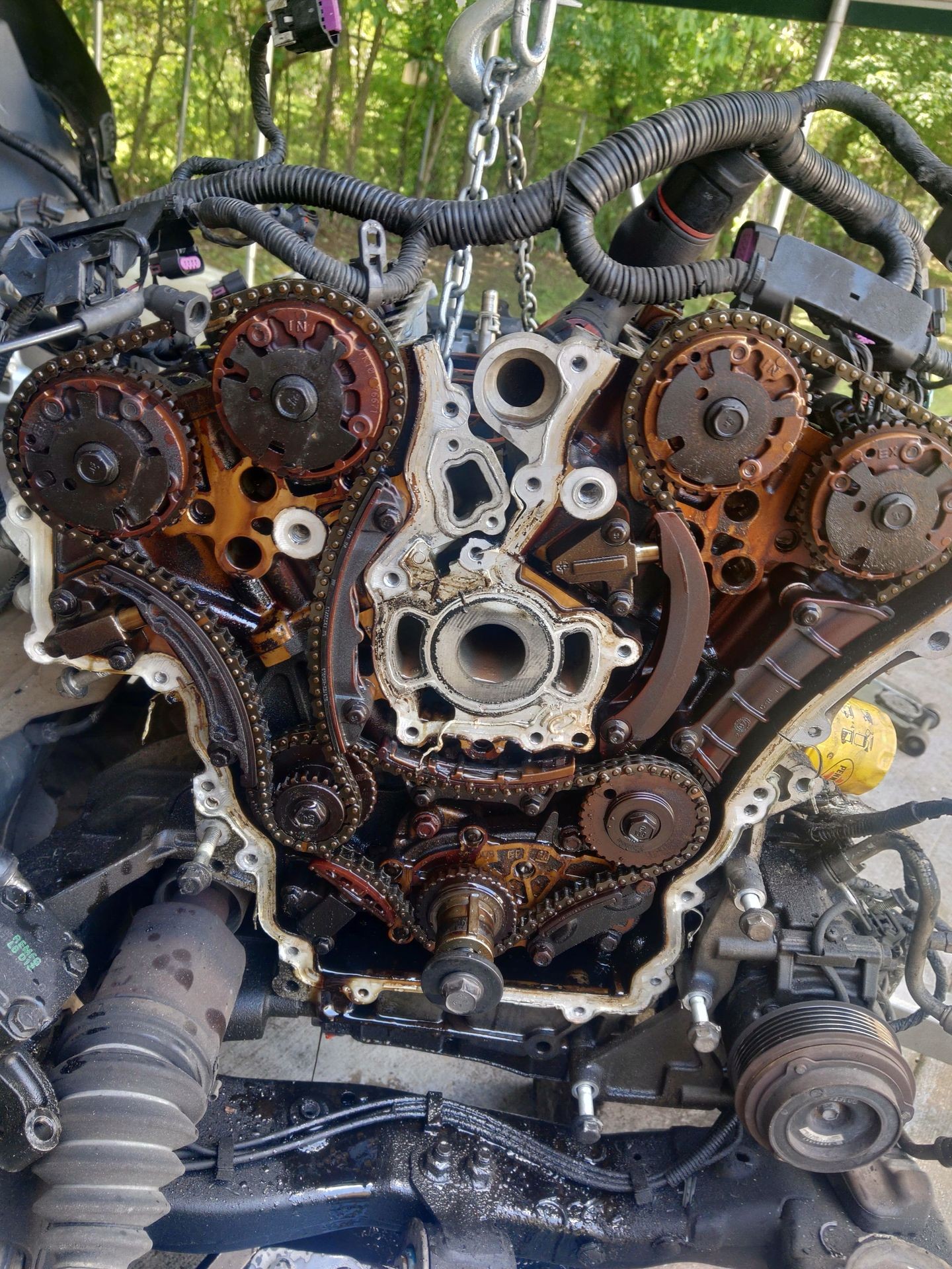 Close-up view of an exposed car engine with visible gears and chains.